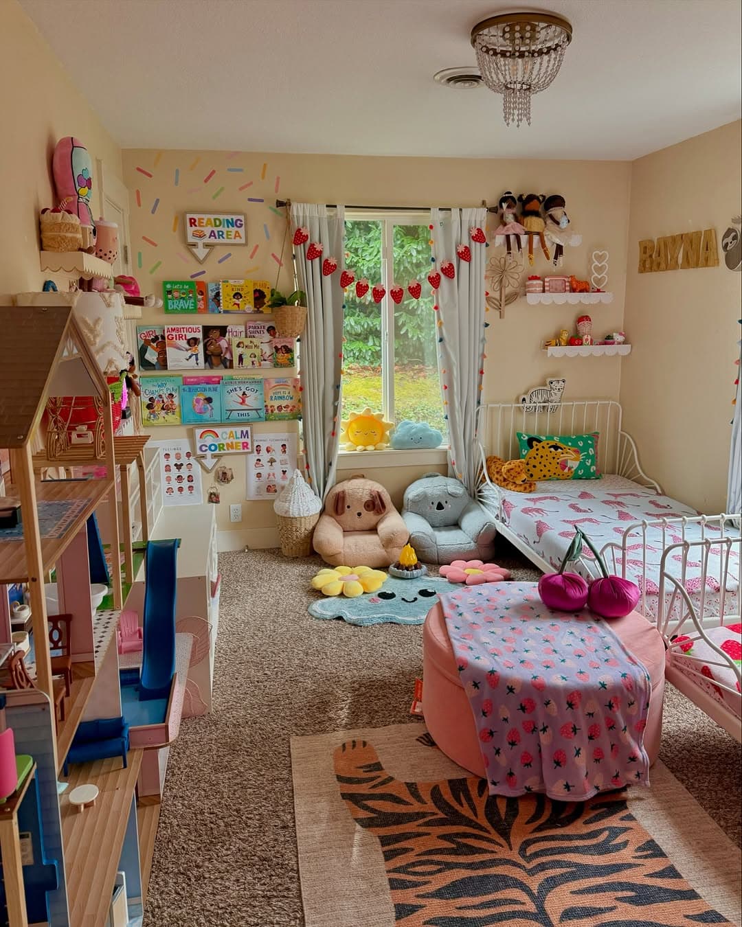 A dreamy toddler girl bedroom features a cozy bed, stuffed animals, bookshelves, and toys. The cute room includes a play area and a reading nook by the window. Walls are adorned with colorful art and twinkling string lights, creating an enchanting space for little ones.